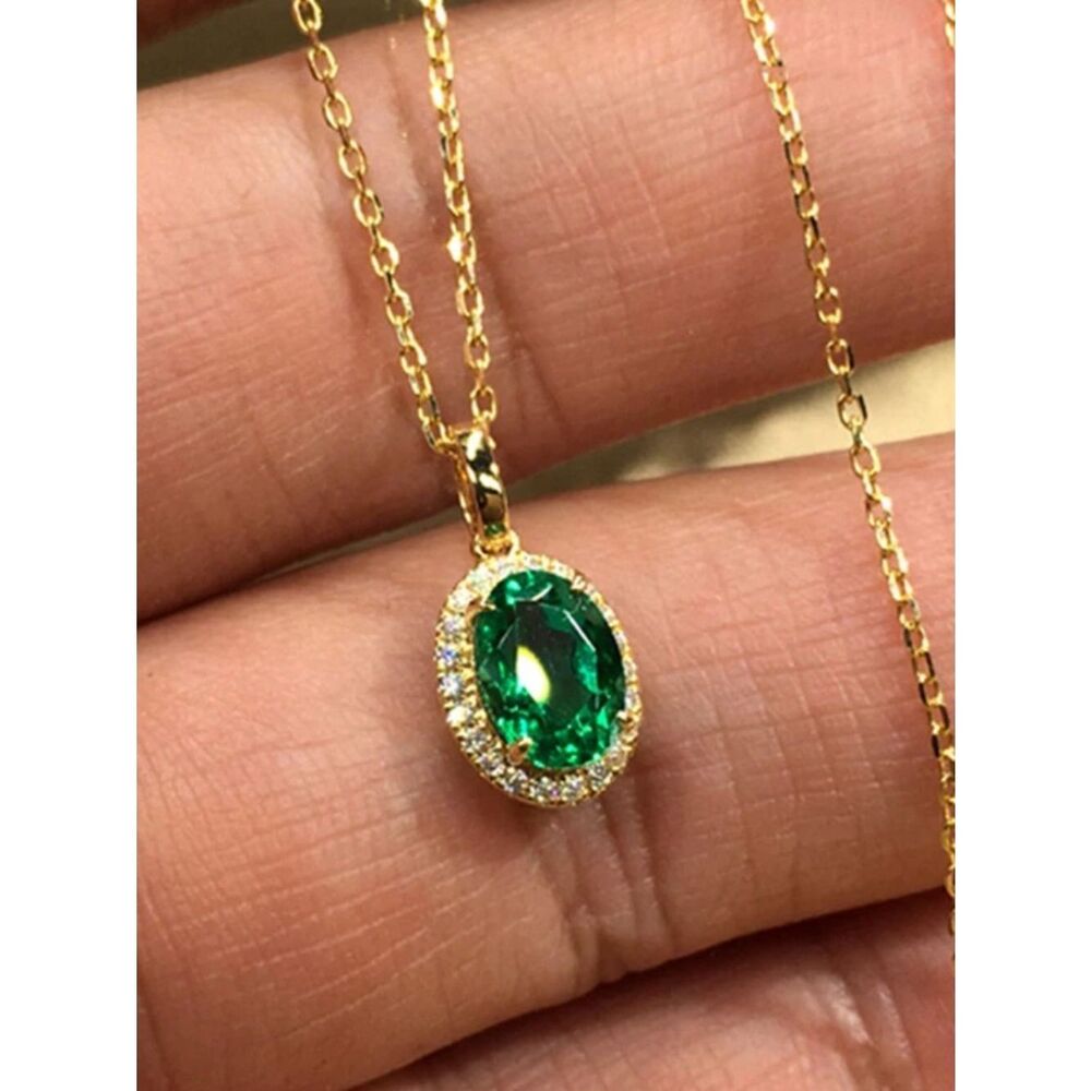 The oval emerald pendant necklace plated in 18k gold with lab created stones